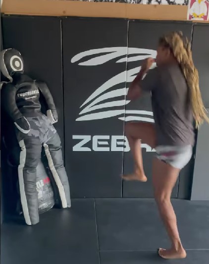 Angela Hill fighting practice with dummy